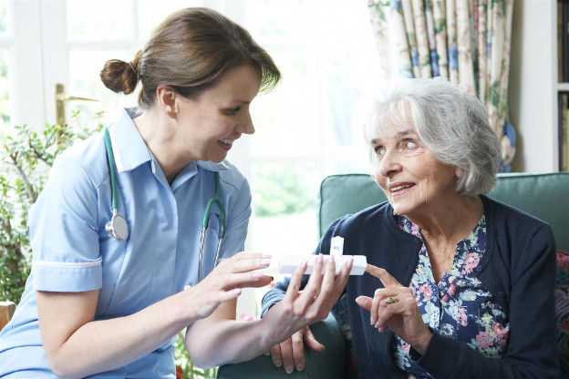 Elder receiving medication from nurse