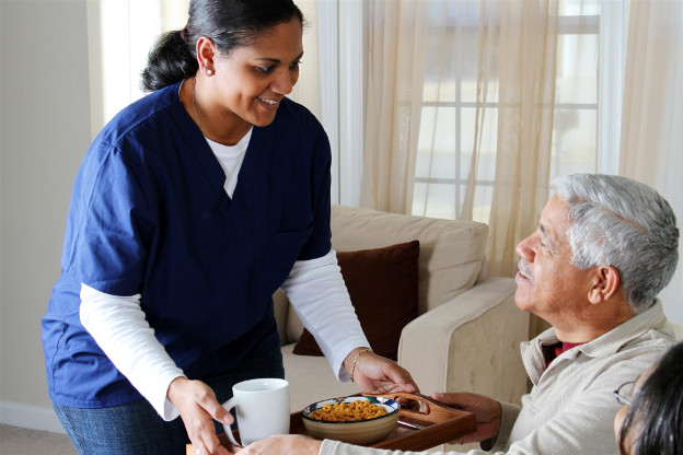 Nurse serving food to hospice patient